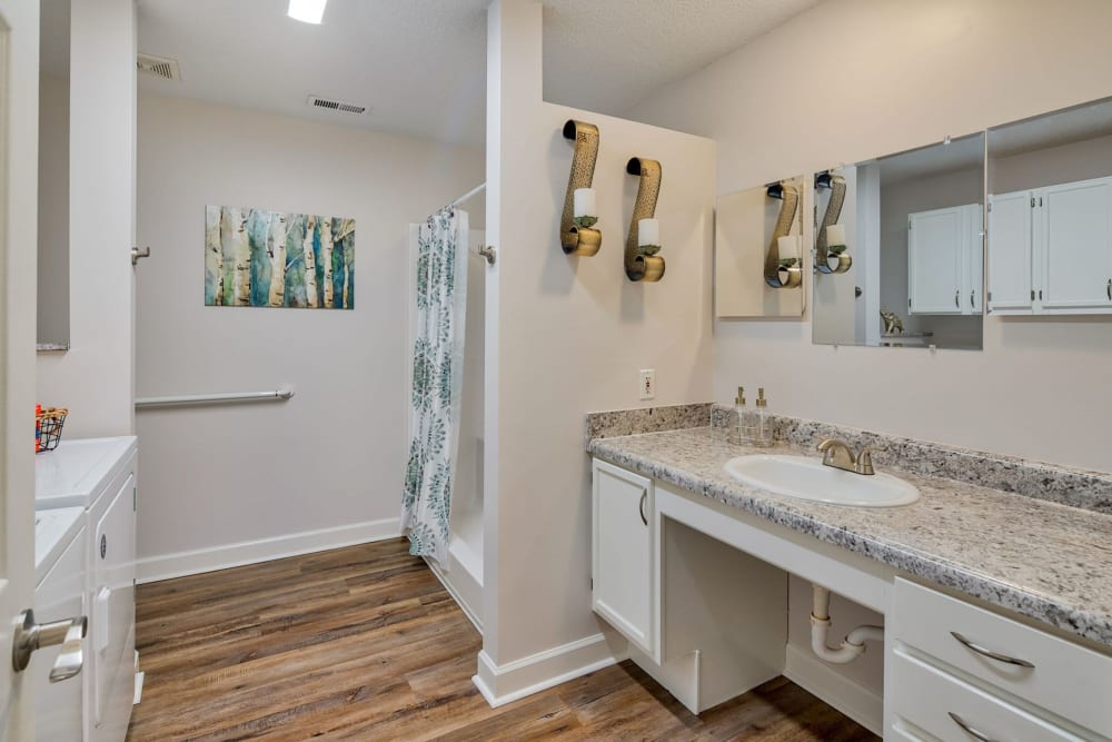 Model bathroom with wood-style flooring at Leisure Living in Evansville, Indiana