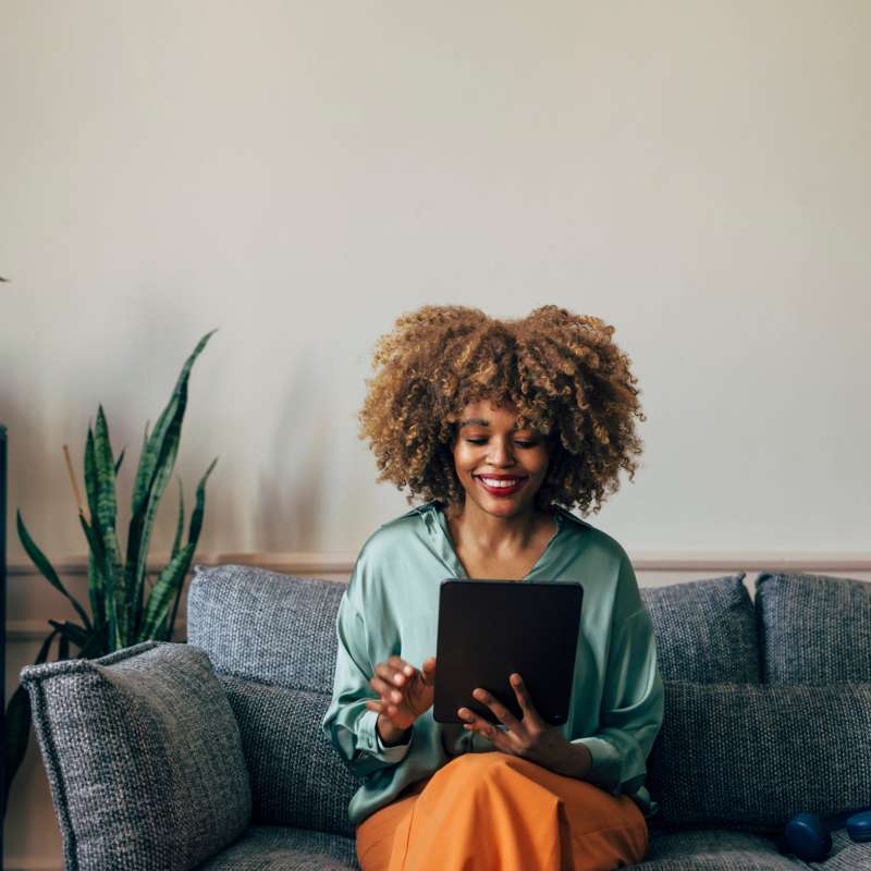 Resident relaxing in her apartment home at Alcove at Alamo Heights in San Antonio, Texas