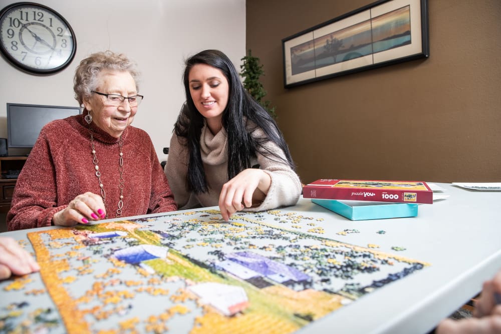 Resident and daughter putting a puzzle together at Parker Place in Parkersburg, Iowa