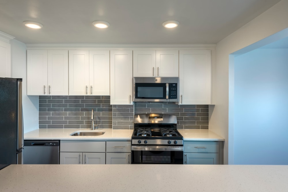 Model kitchen with large counter at Ruxton Towers Apartments in Towson, Maryland