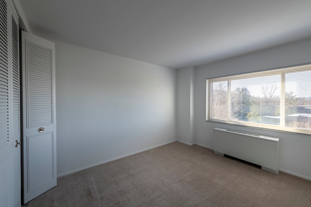Bedroom with large window at Ruxton Towers Apartments in Towson, Maryland