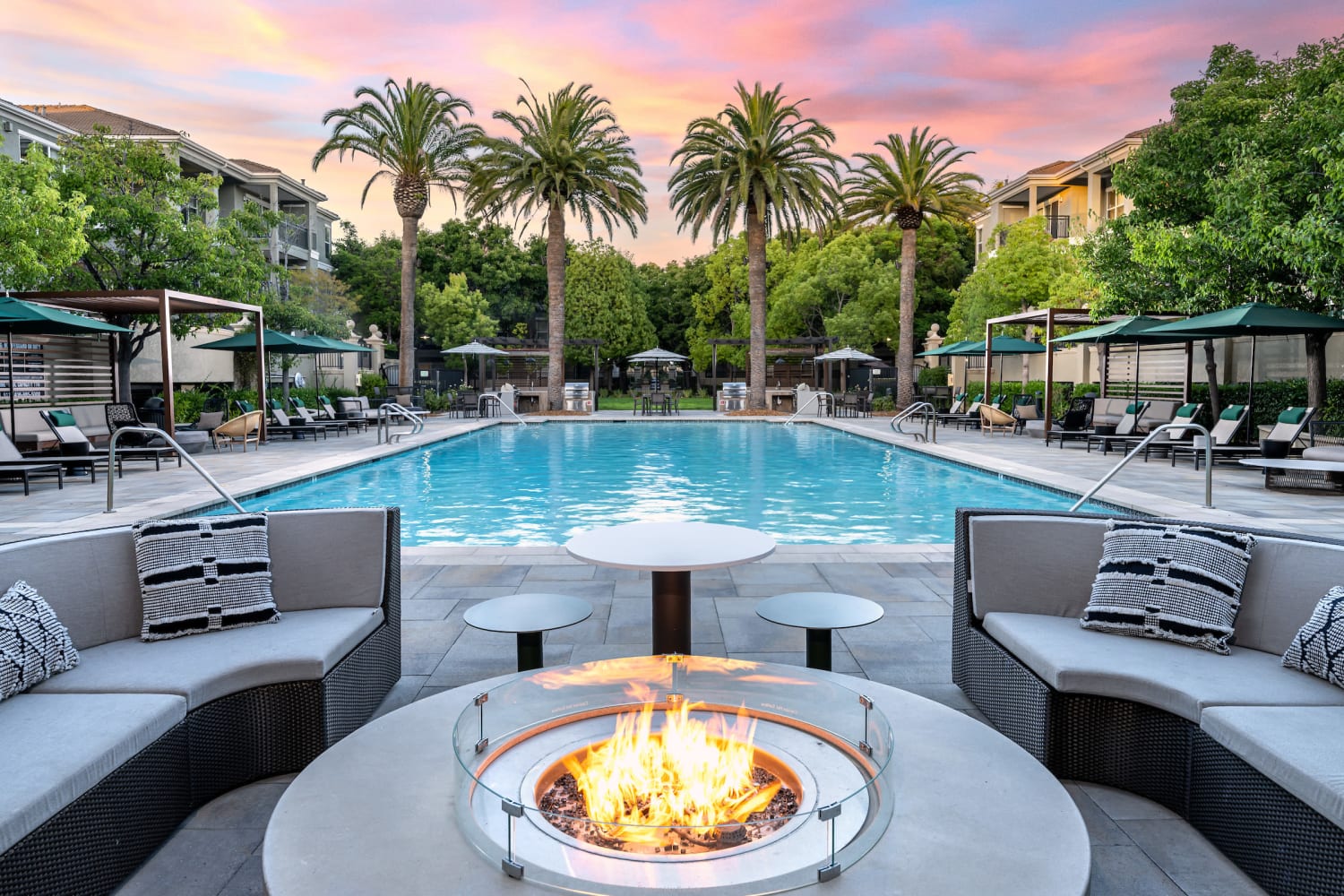 Beautiful exterior pool and gas firepit at The Carlyle in Santa Clara, California