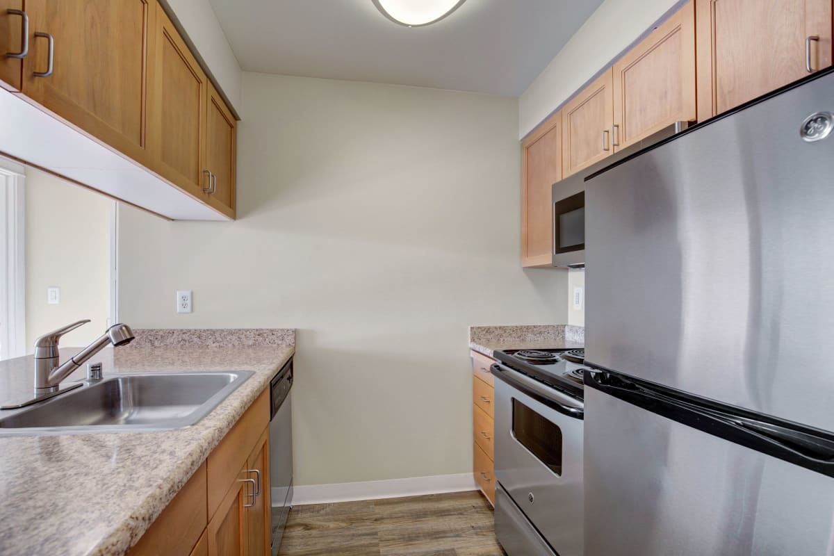 Ample cupboard storage and stainless-steel appliances in an apartment's kitchen at Vantage Park Apartments in Seattle, Washington
