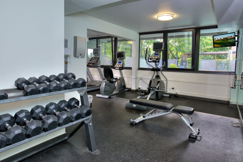 Fitness center with individual workout stations at Harrison Tower in Portland, Oregon