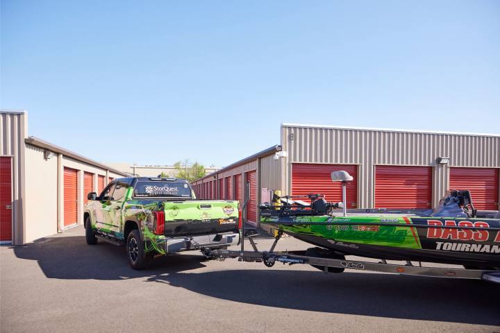 Truck towing fishing boat in storage complex