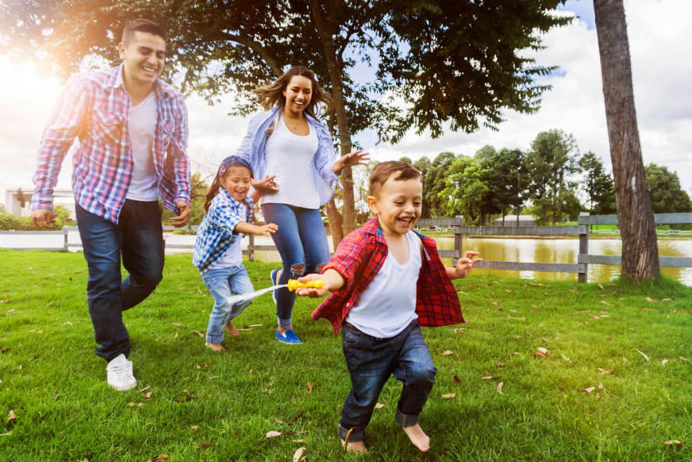 A happy resident family having a good time at a park near Array in Austin, Texas