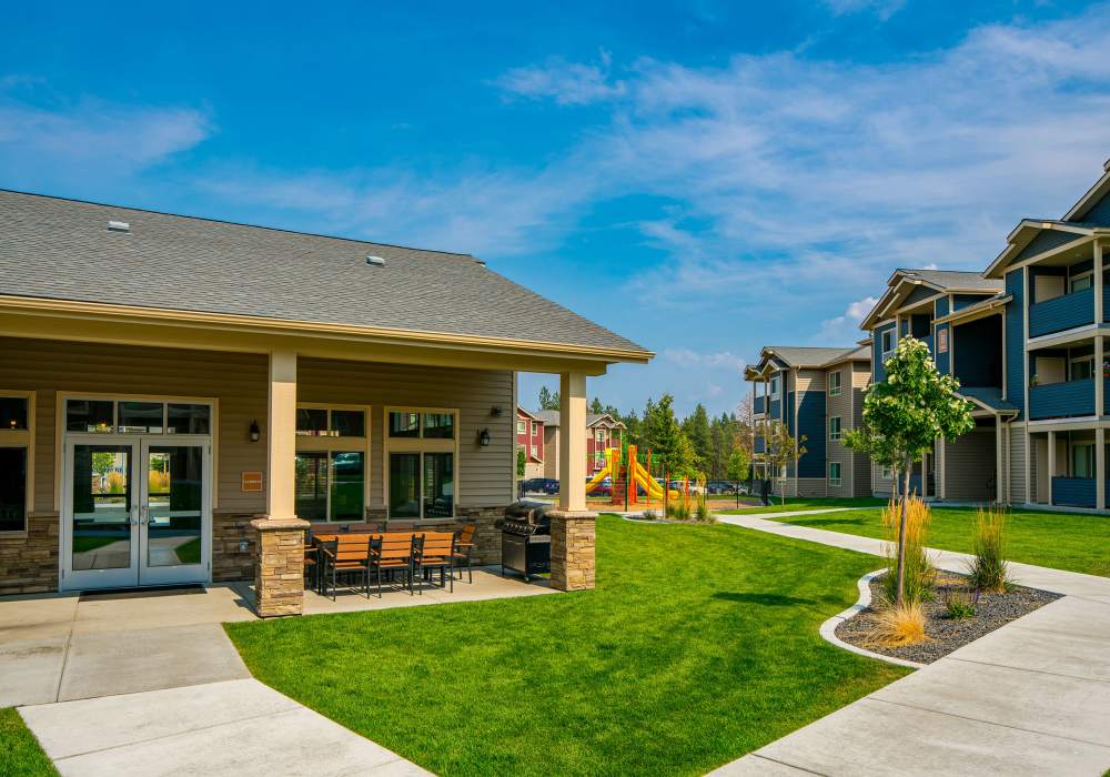 Outdoor seating by the clubhouse and playground at Copper River in Spokane, Washington