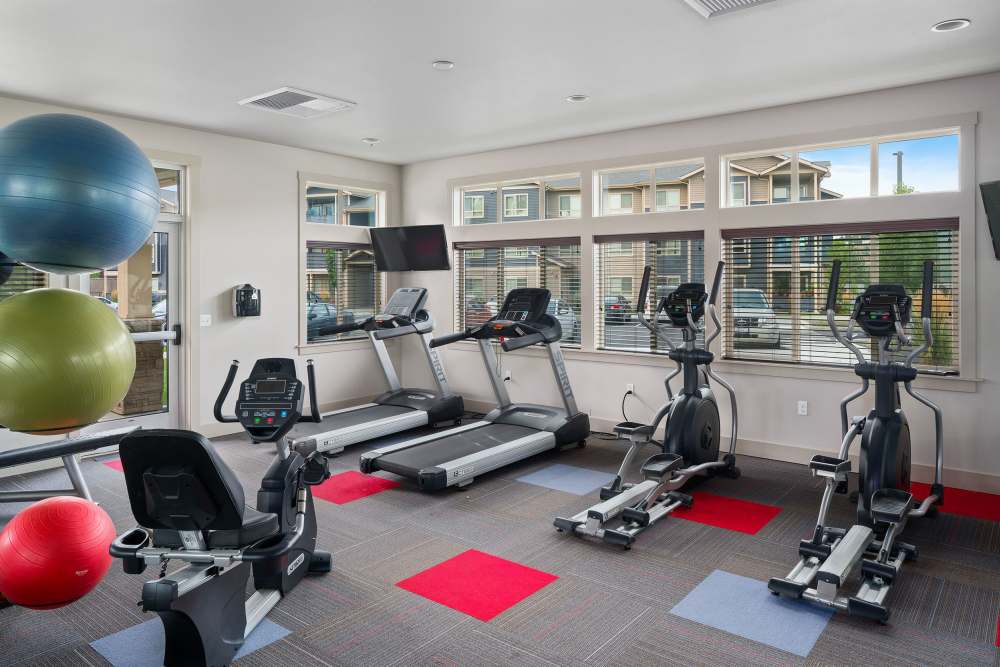 Spacious state-of-the-art fitness center with multiple treadmills and TVs at Copper River in Spokane, Washington