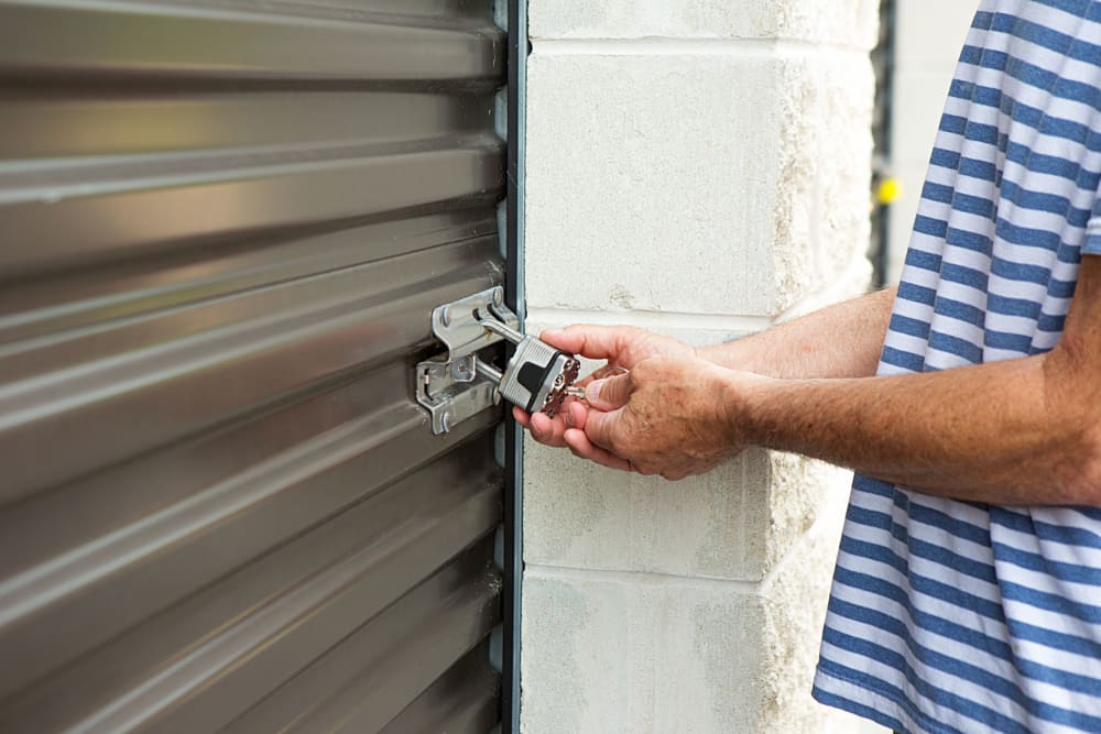 A man unlocking a storage unit at Urban Storage - Sprague Ave in Tacoma, Washington