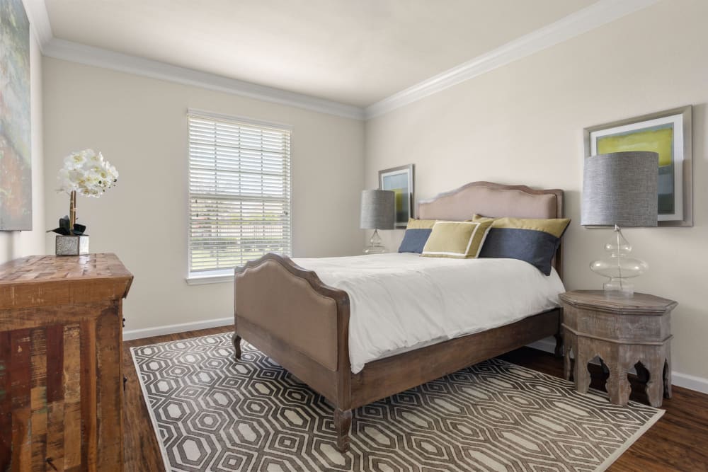 Very well-furnished model home's primary bedroom at Olympus Woodbridge in Sachse, Texas
