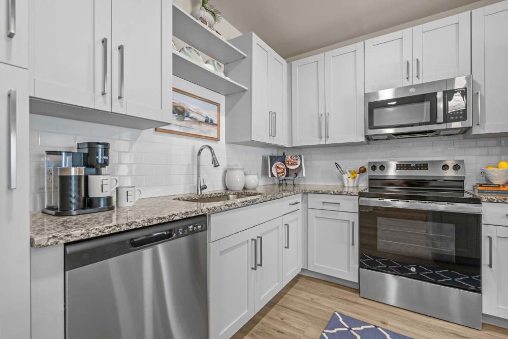Resident cooking in his apartment kitchen at The Edison at Farrow Commons in North Myrtle Beach, South Carolina