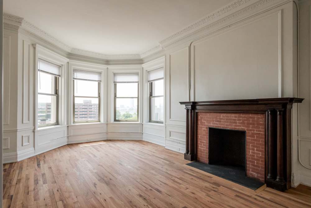 Spacious room with fireplace and hardwood flooring at Detroit Living in Detroit, Michigan