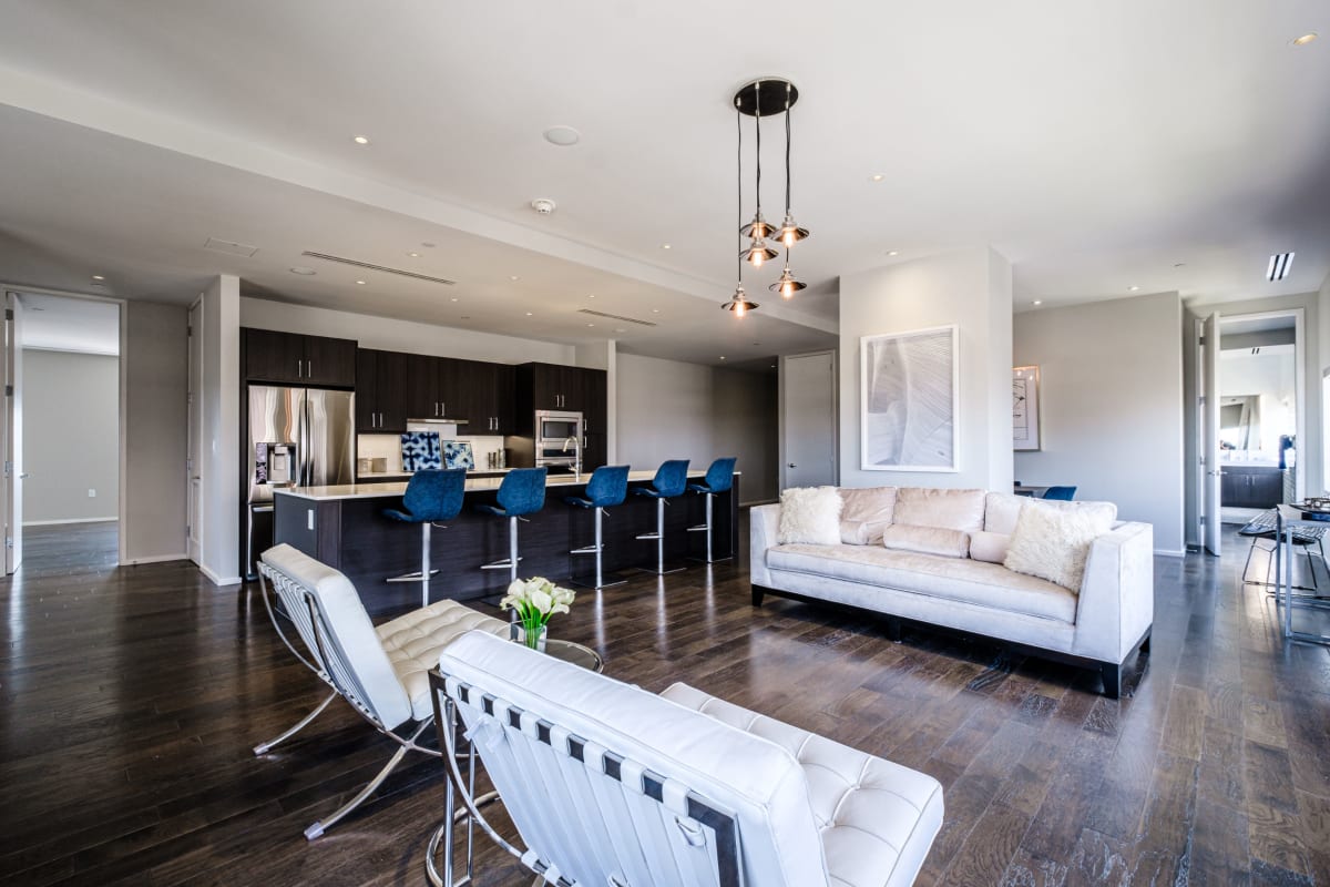 Living room with wood-style flooring at The Statler Residences, Dallas, Texas