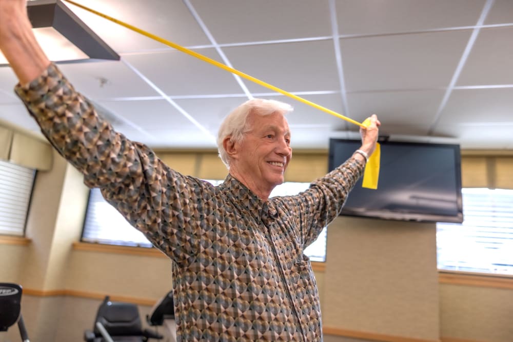 Resident exercising with an exercise band.