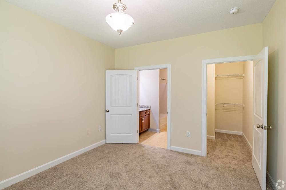 Spacious bedroom with adjoining walk-in closet at Reserve at Regents Center in Lexington. NC