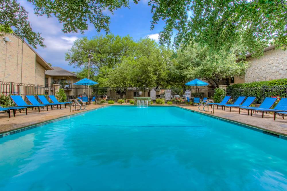 Swimming pool with lounge seating at Del Prado at Texas Star in Euless, Texas