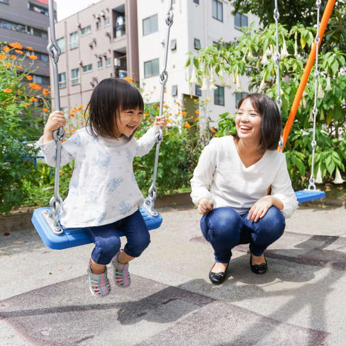 Mother and child on swing at playground near Ramona Vista in Ramona, California