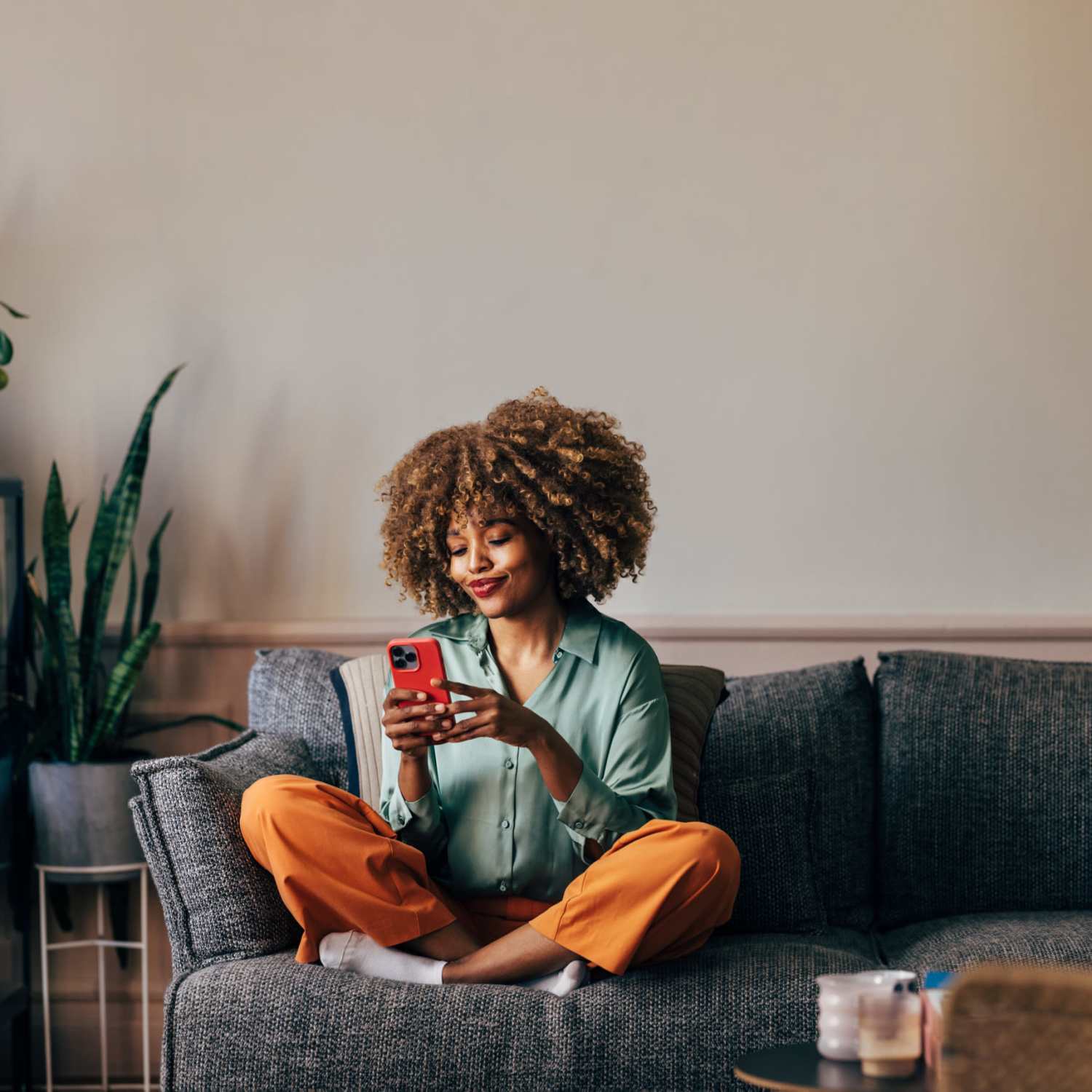 Woman relaxing on the couch at Reeds Landing Apartments in Edmond, Oklahoma  