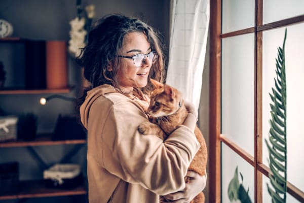 Woman holding her cat in her apartment home at Bensons Corner Apartments in Fallston, Maryland 