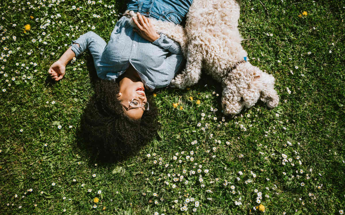Resident lying in a nearby park with her dog | The Grove at Oakbrook in Summerville, South Carolina