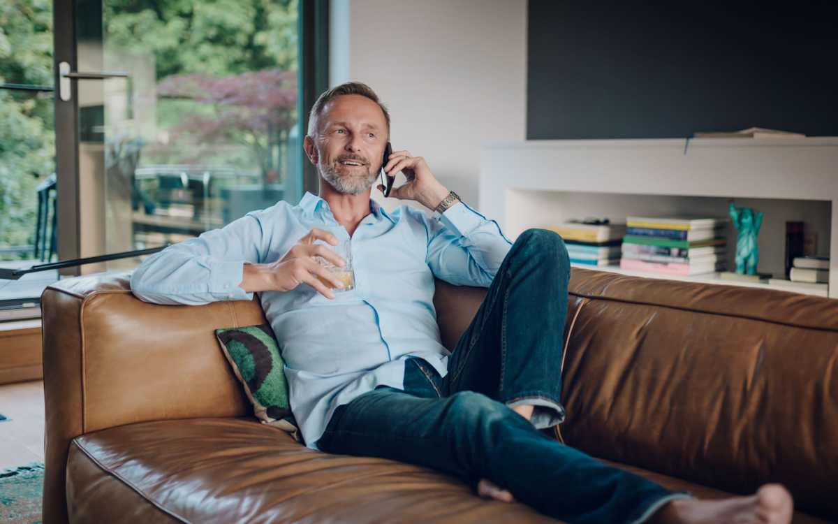 Resident relaxing on couch at The Residences at Patapsco in Ellicott City, Maryland