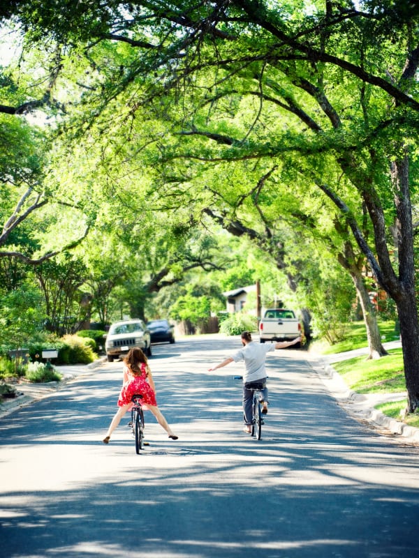 Residents riding bicycles down a street near Bellrock La Frontera in Austin, Texas