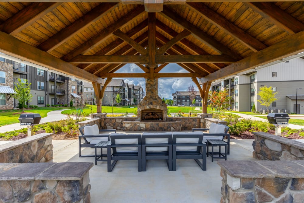 Outdoor firepit and BBQ grilling area at The Holston | Apartments in Weaverville, North Carolina