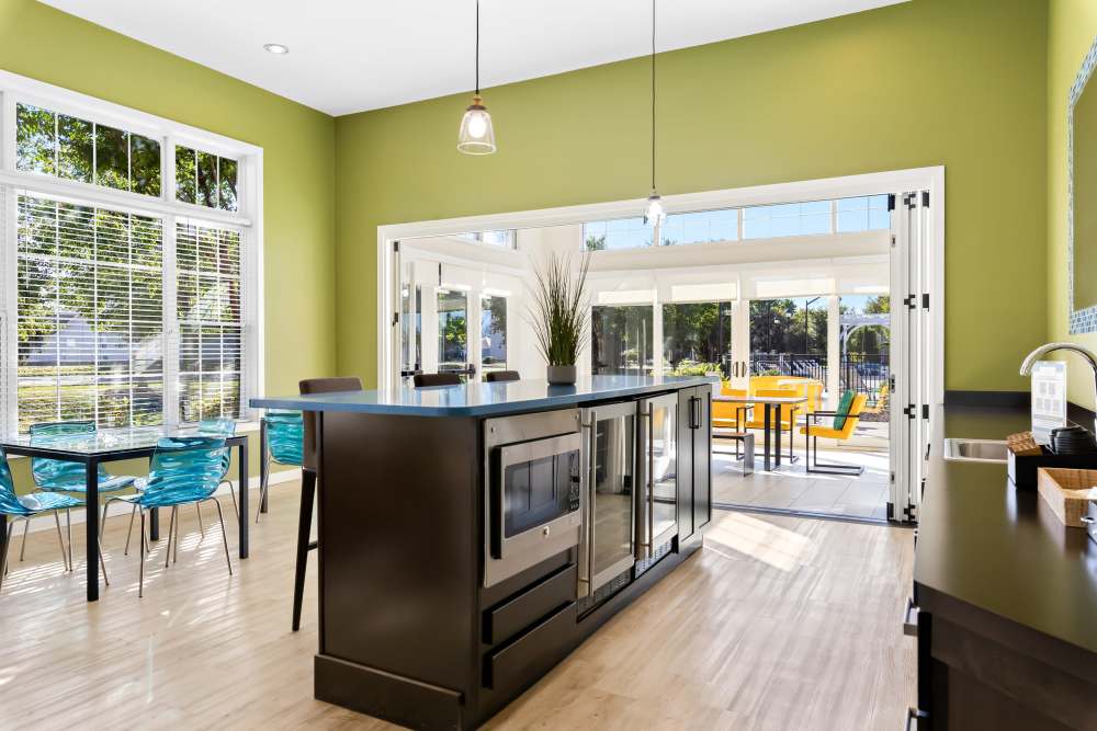 Central Island With a Black Countertop And Dark Wood Cabinetry at Arbor Brook in Murfreesboro, Tennessee