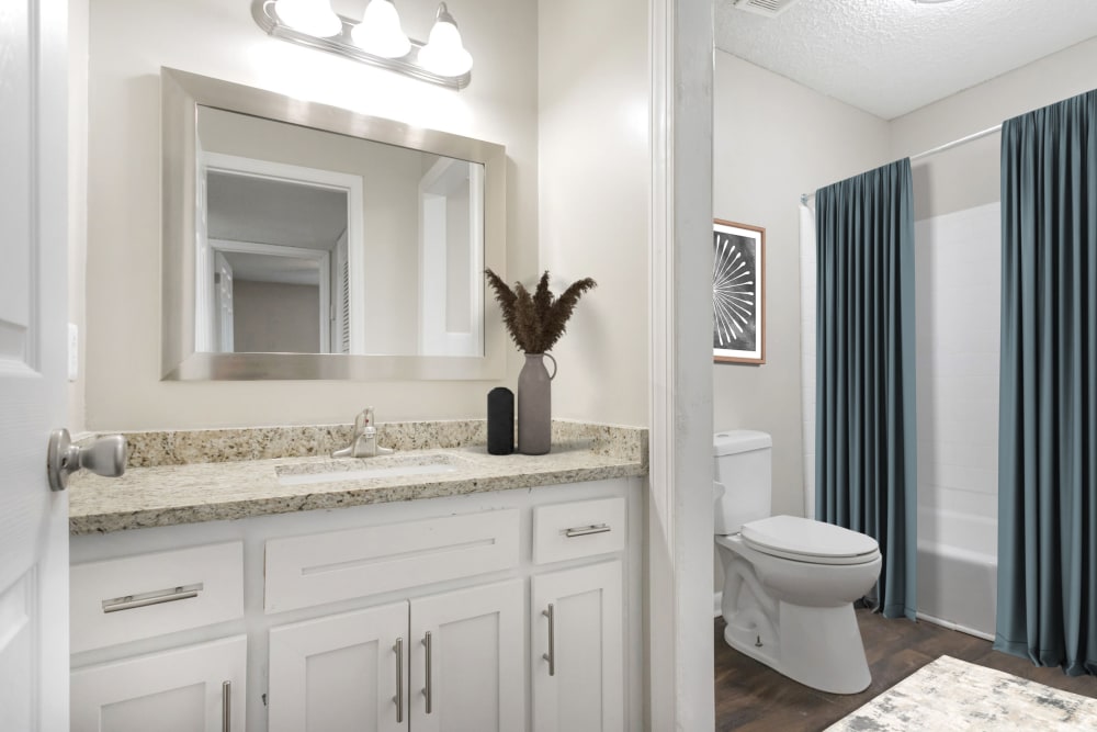 Bathroom with granite counters at Parkview Flats Apartments in Murfreesboro, Tennessee