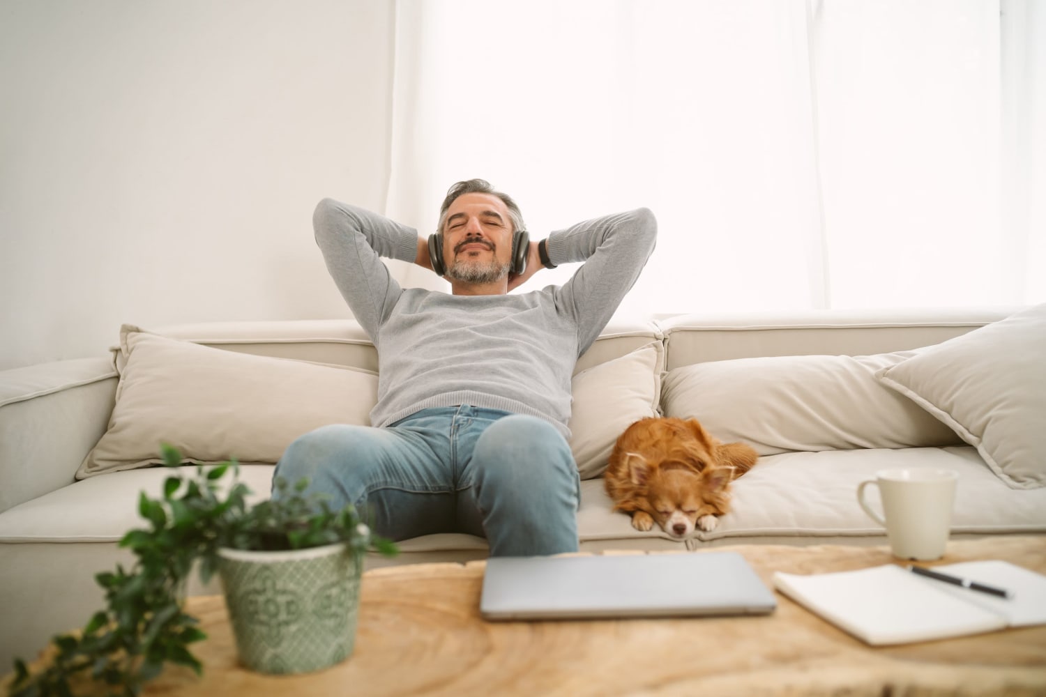 Resident and his dog relaxing on the couch at Admiralty Apartments in Port Townsend, Washington