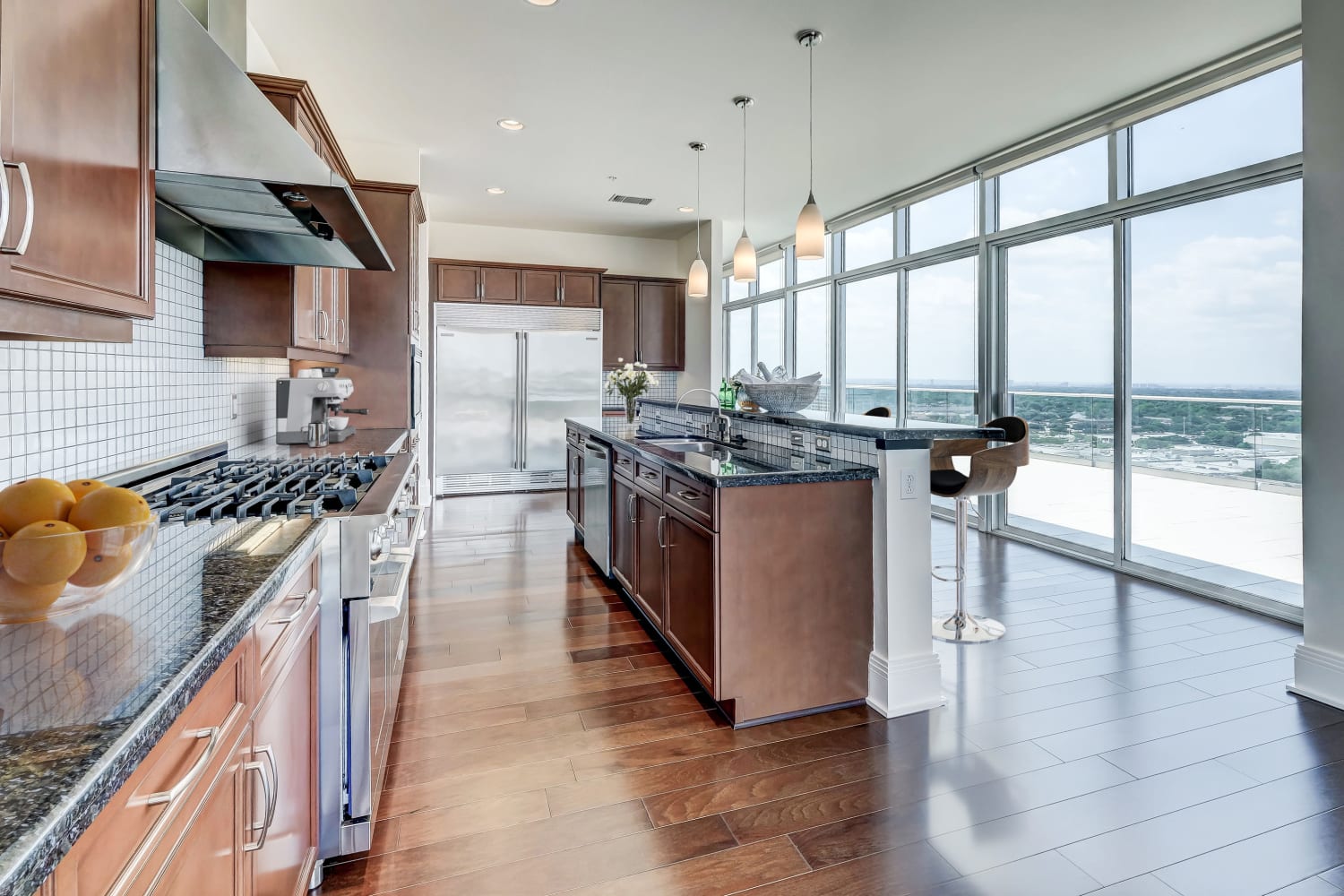 Sleek kitchen with stainless steel appliances at The Heights at Park Lane in Dallas, Texas