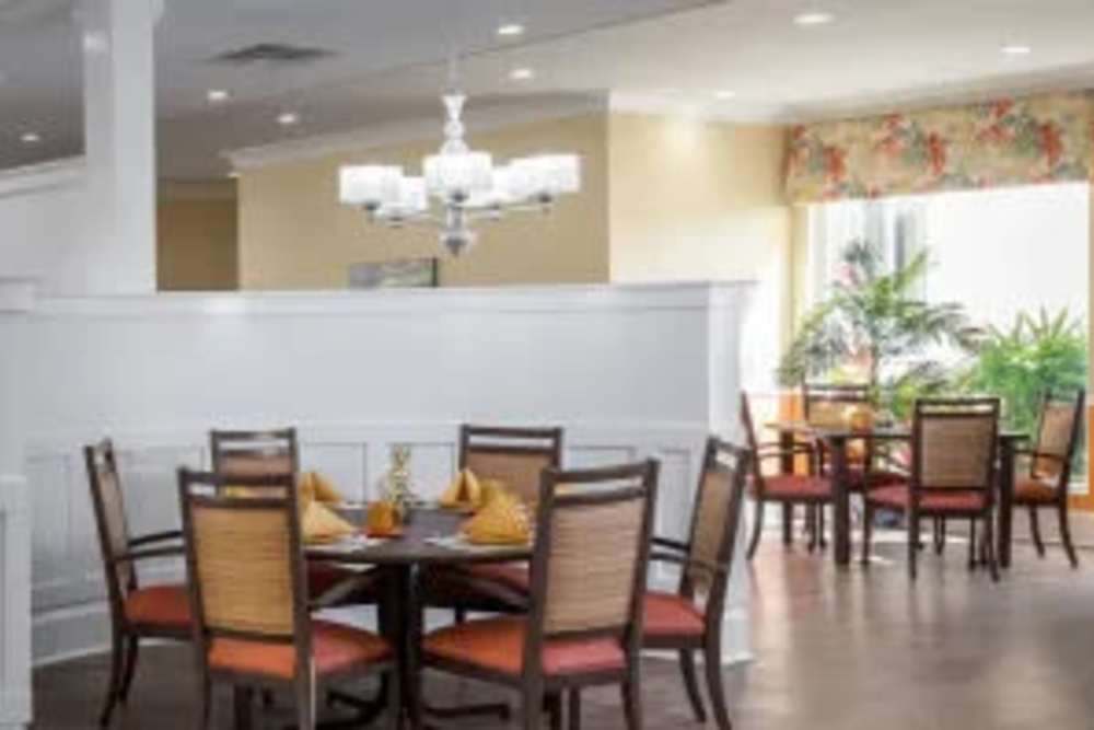 Dining area with large window at The Pineapple House at Sapphire Lakes in Naples, Florida
