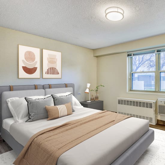 Model bedroom with beige accents at Goodwill Terrace in Astoria, New York