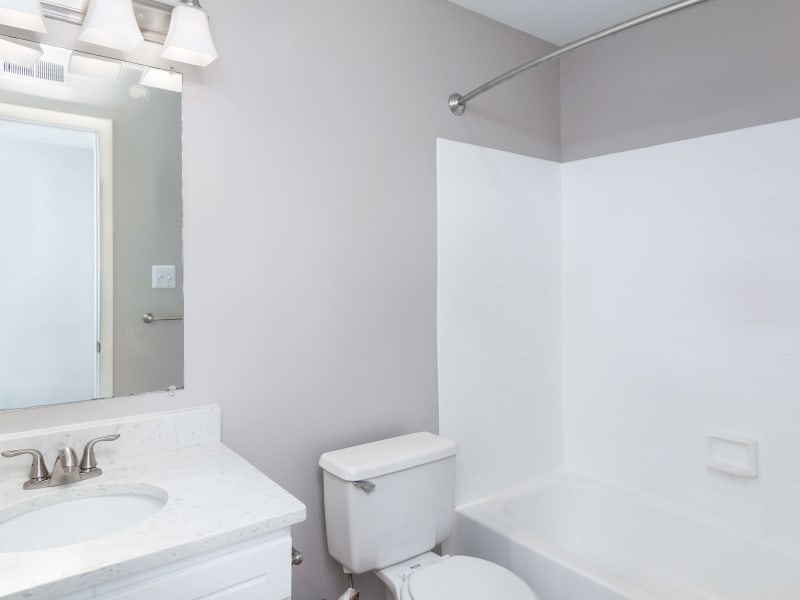 A modern apartment bathroom with a bathtub at Springwoods at Lake Ridge in Woodbridge, Virginia