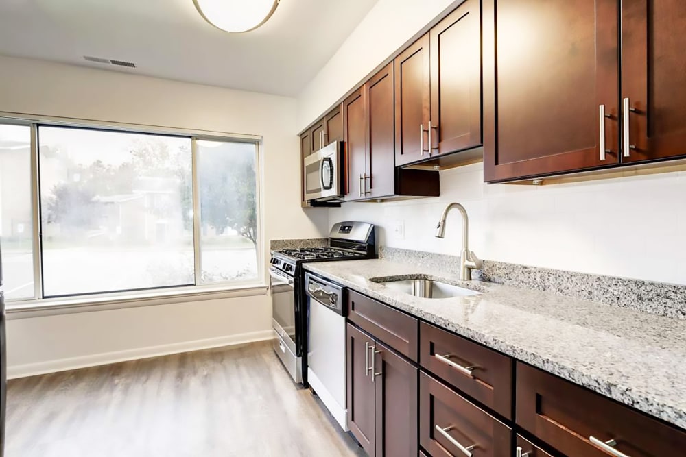 Model kitchen with large windows at Hampton Manor Apartments and Townhomes in Cockeysville, Maryland