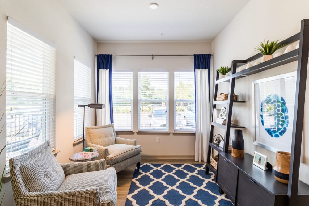 Model living room with large windows at The Carlton at Bartram Park in Jacksonville, Florida