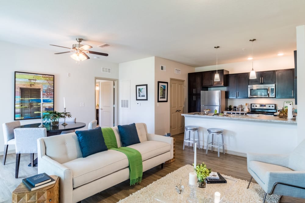 Model living room and kitchen with bar seating at Lakeline at Bartram Park in Jacksonville, Florida
