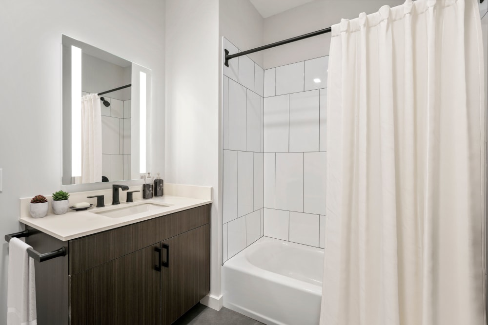 Upgraded bathroom sink, led backlit mirror and tile shower/tub at Anden in Weymouth, Massachusetts