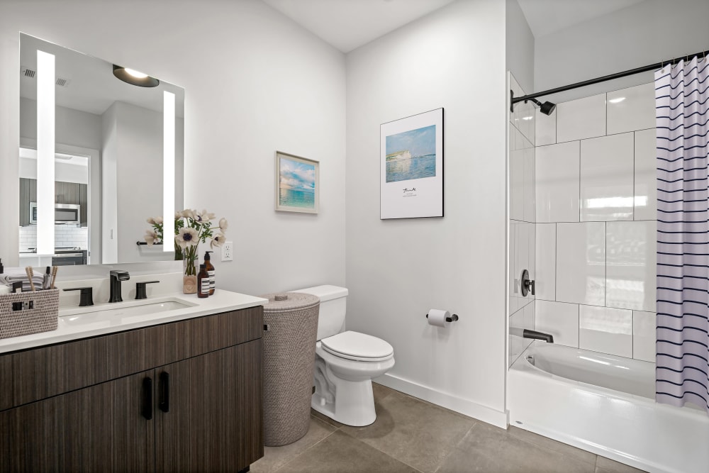 Upgraded bathroom sink, led backlit mirror and tile shower/tub at Anden in Weymouth, Massachusetts