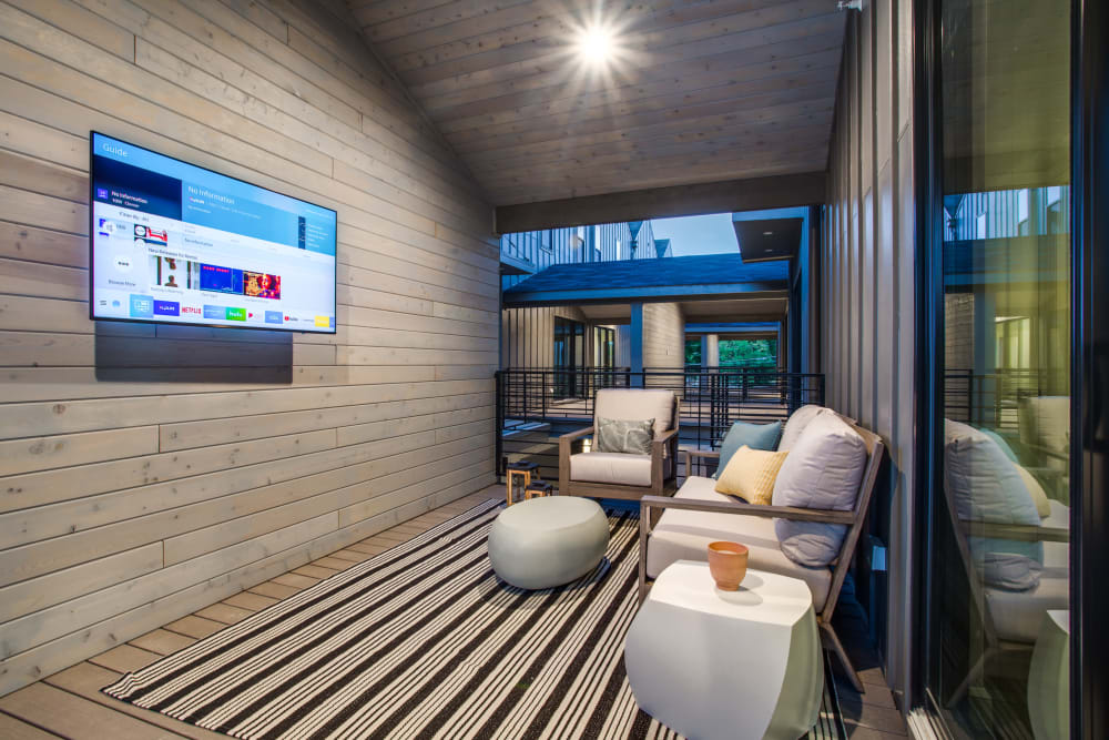 Resident balcony with large television at The Collection Townhomes in Dallas, Texas