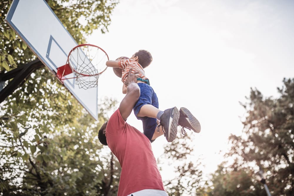 Father and son playing basketball at La Prensa Libre in Los Angeles, California