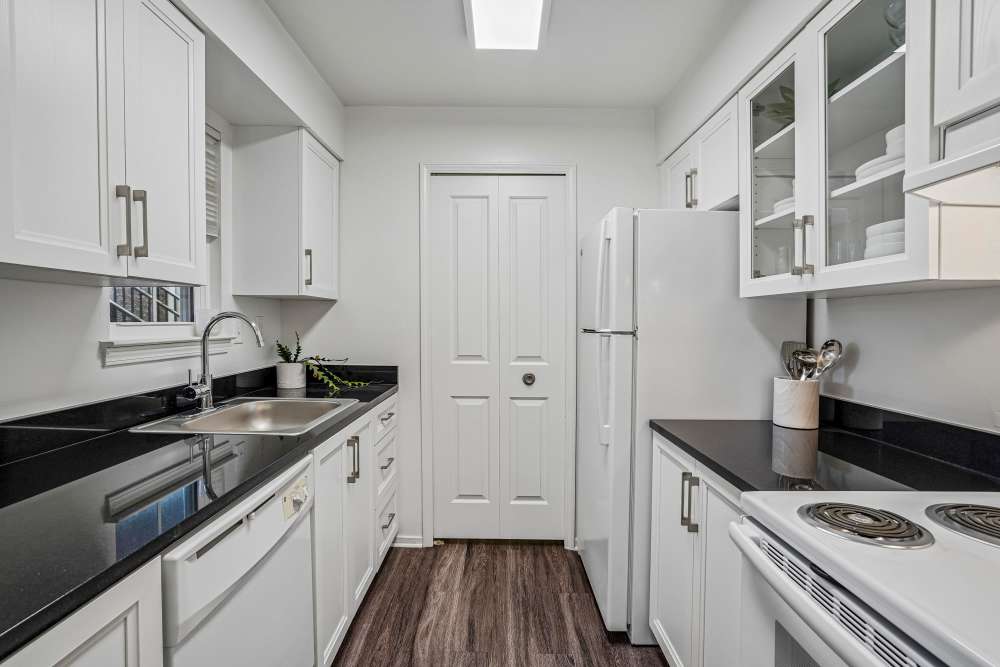 Kitchen with white cabinets and appliances at Citation Club in Farmington Hills, Michigan
