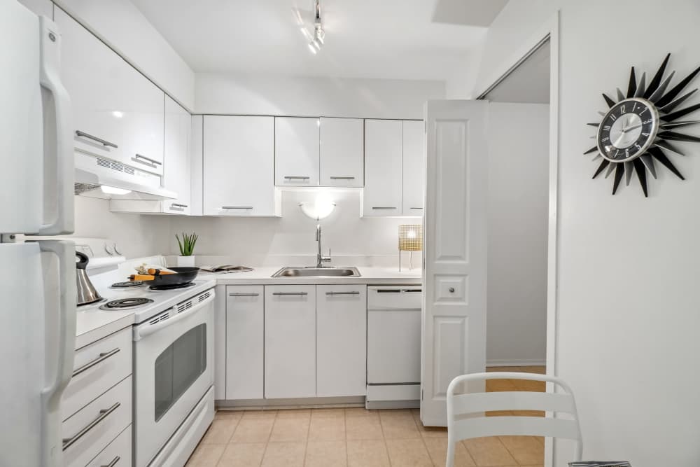 Kitchen with White Cabinets and Appliances at Saddle Creek Apartments in Novi, Michigan