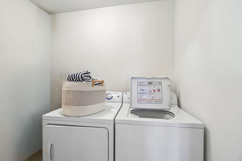 Stacked in-home washer and dryer at Saddle Creek Apartments in Novi, Michigan
