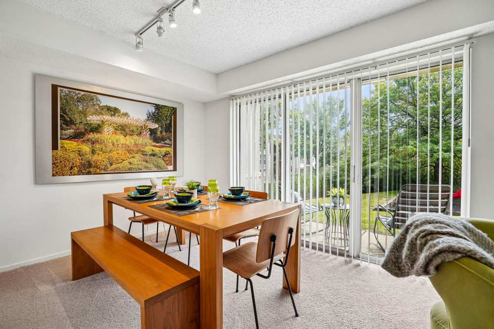 Dining room and private patio of a model apartment at Briar Cove Terrace Apartments in Ann Arbor, Michigan