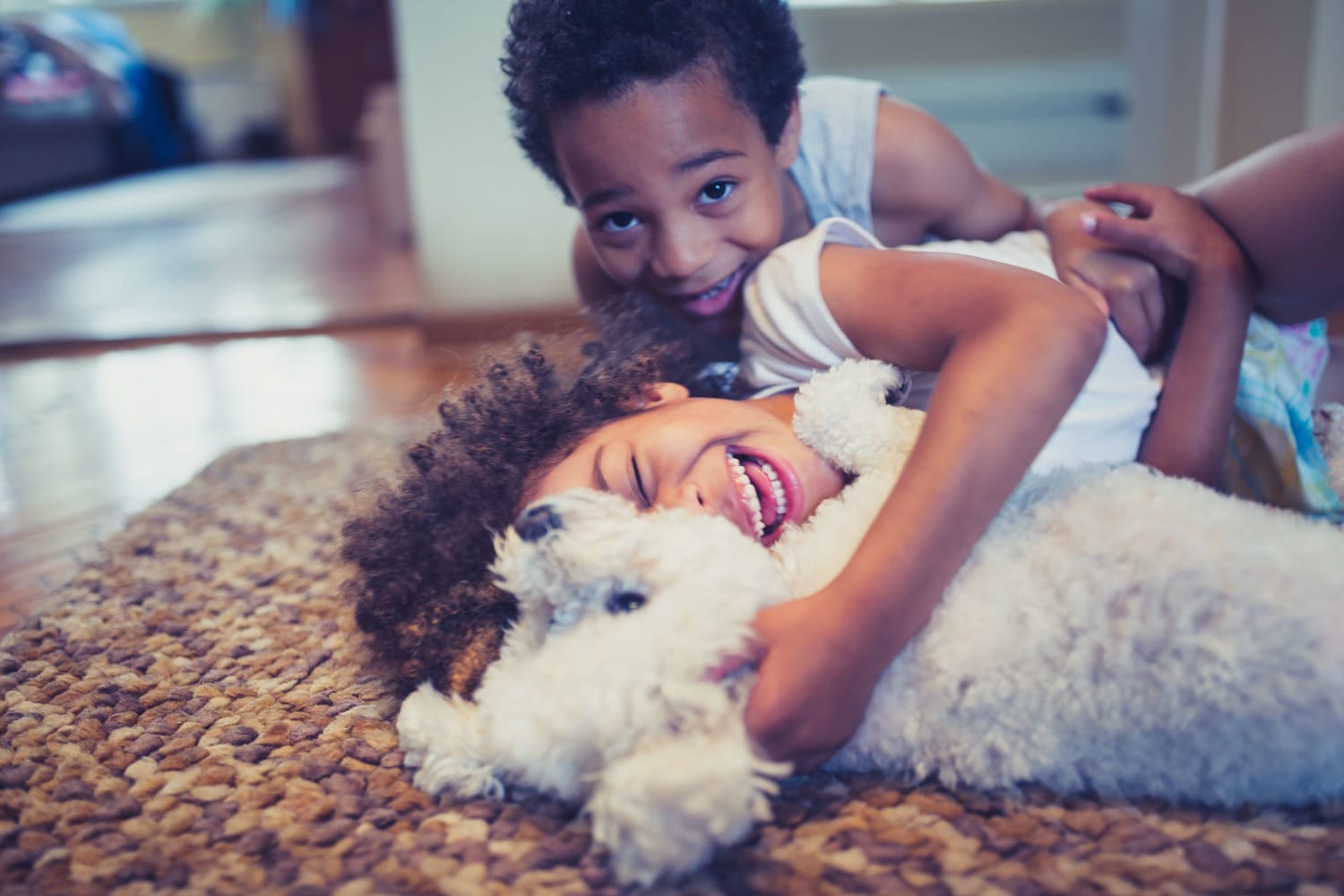 Children playing with their pup in their home at The Belaire in Marietta, Georgia