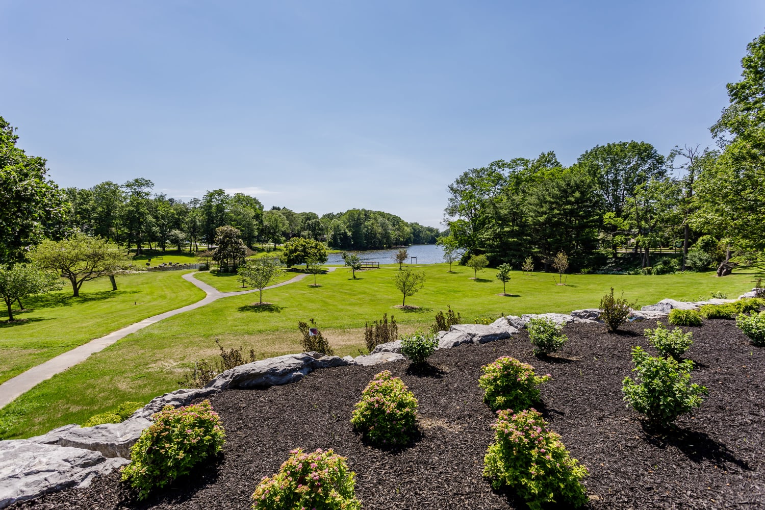 Expansive green space and landscaping, overlooking a lake