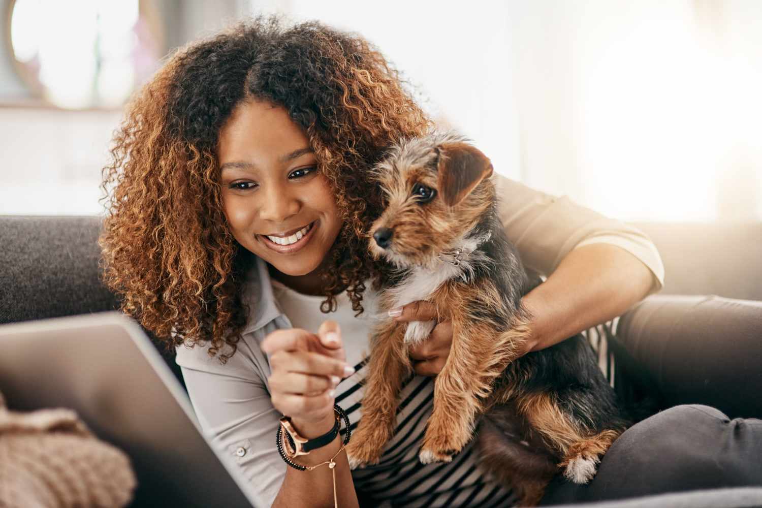 Resident holding her happy pup in their new home at Thomaston Crossing in Macon, Georgia