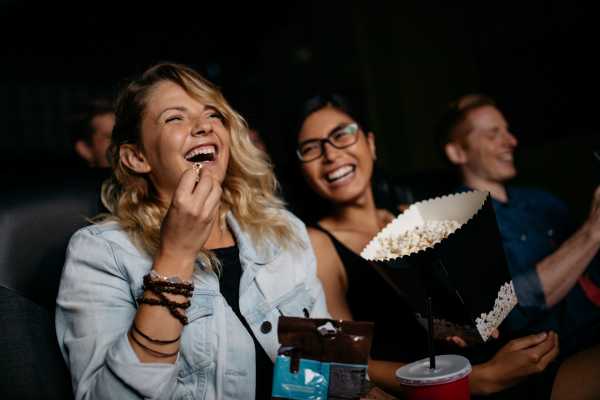 Residents enjoying their movie with popcorn in the theatre near Prospera at Homestead in Dixon, California
