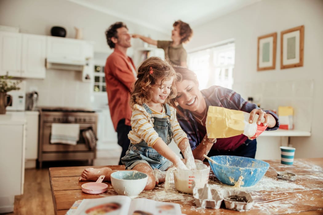 Family making a mess while baking at Orchard Hills Apartments in Whitehall, Pennsylvania